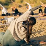 India Williams from Mystical yoga practising yoga on the beach