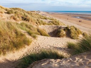 Stroll the dunes and the flat stretches on the miles of Camber Beach