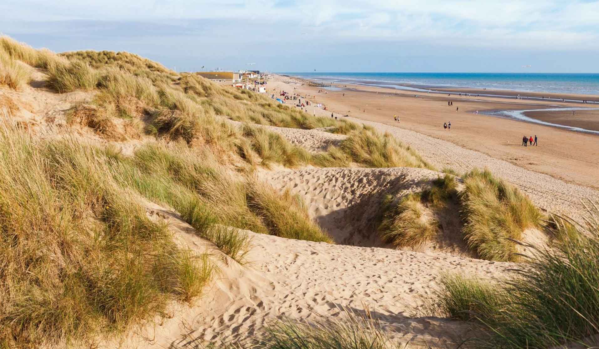 Stroll the dunes and the flat stretches on the miles of Camber Beach